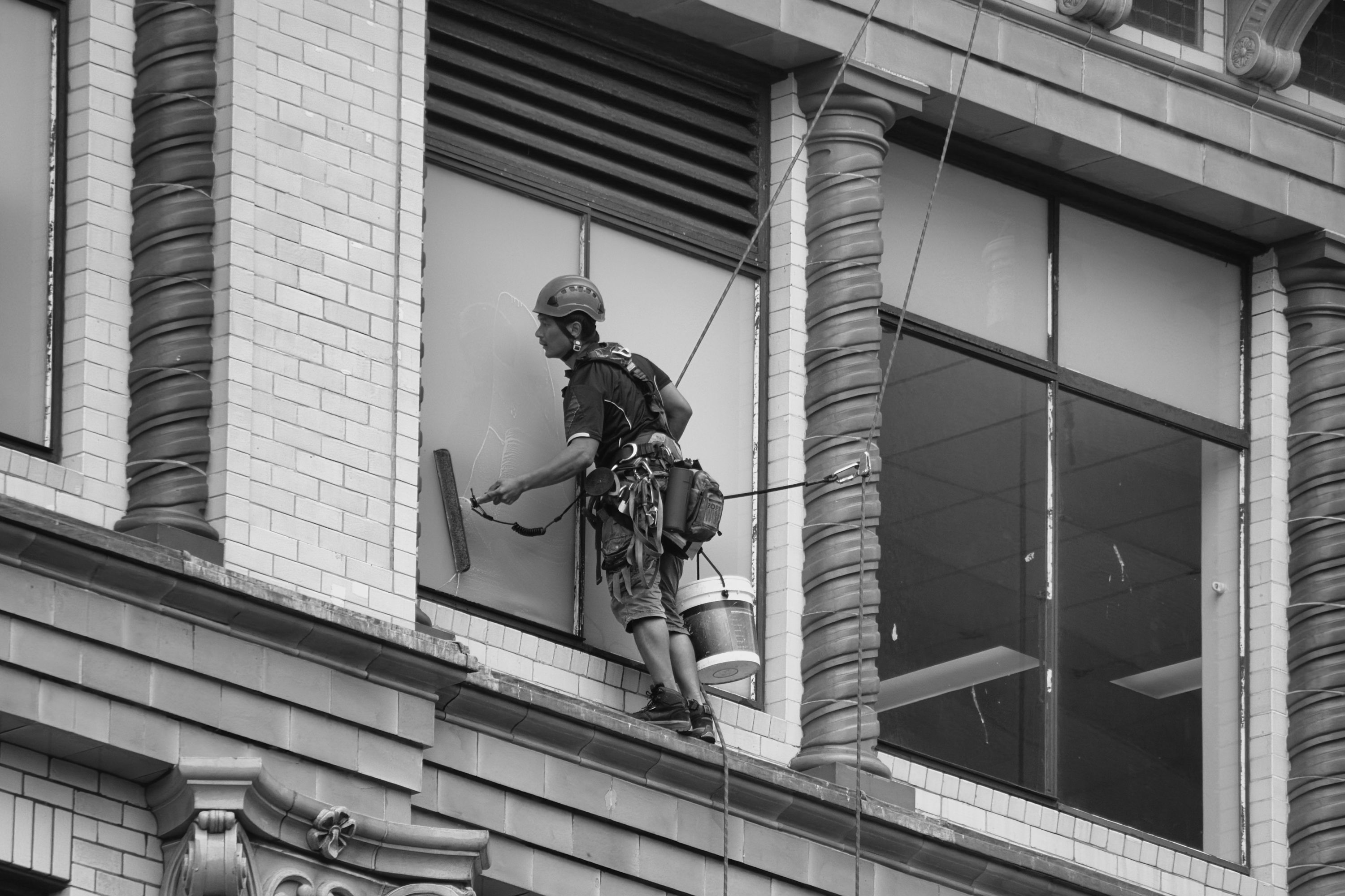 Window cleaner working on a glass exterior